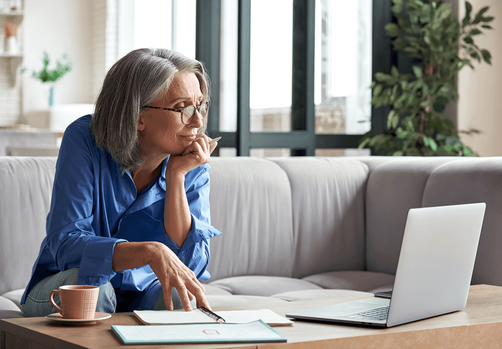 a woman taking notes during a virtual meeting.png