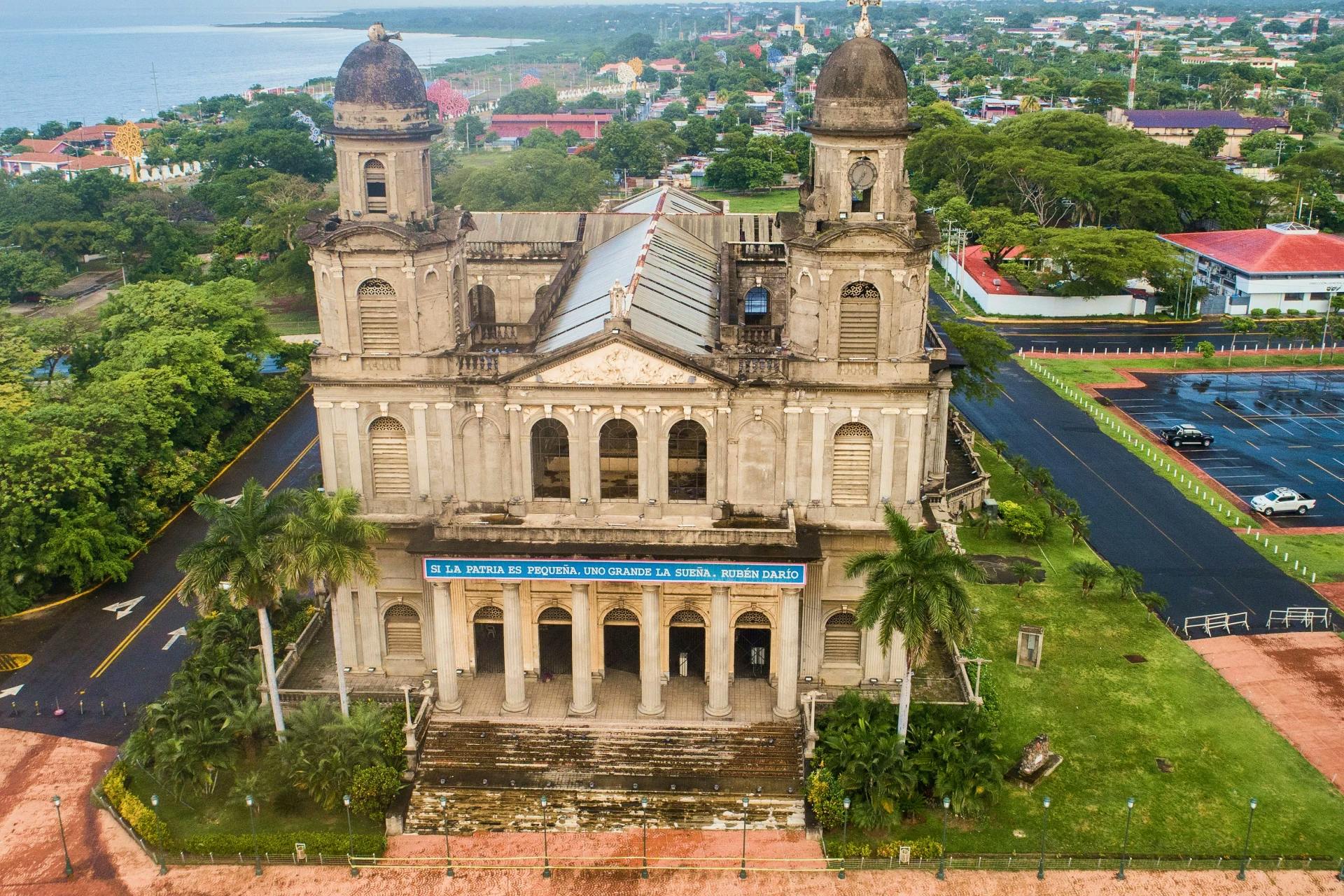 An aerial view of a church near the ocean.