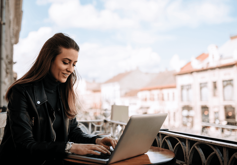 A woman working happily from a new country