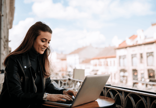 A woman working happily from a new country