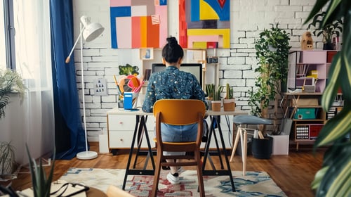 A woman at her desk with a work from home stipend from her employer.