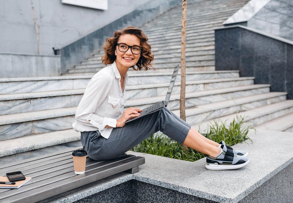 woman sitting with her laptop on stairs