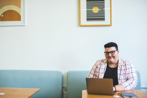 person sitting in a cafe using a laptop