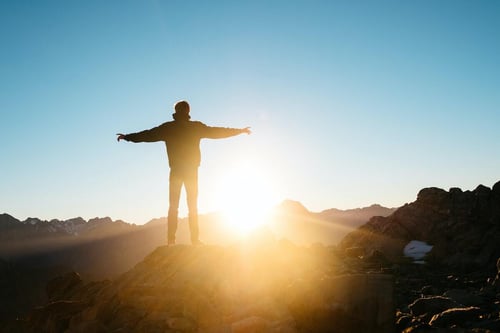 person welcoming the sunrise