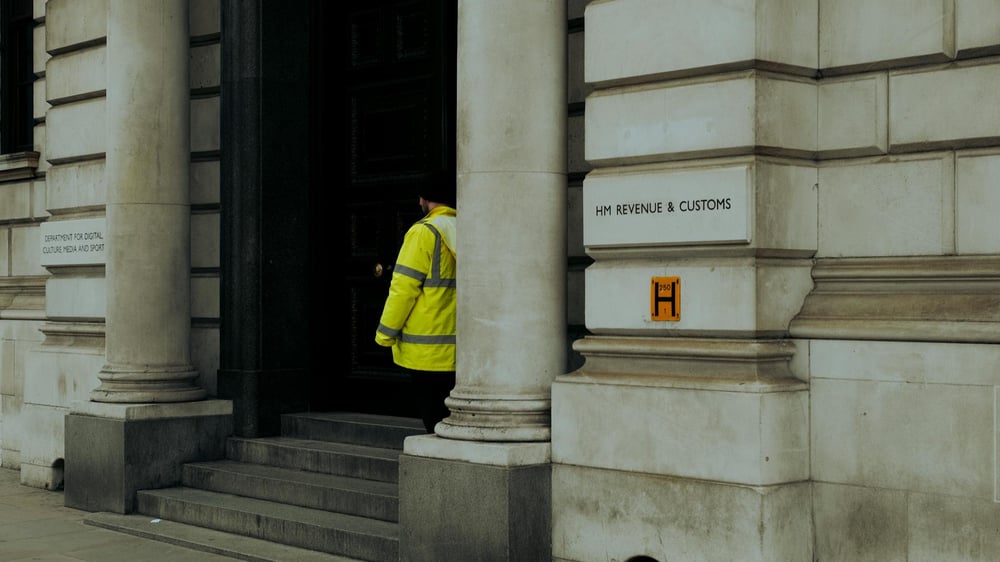 Short-range exterior shot of the entrance to a HMRC building in the UK.