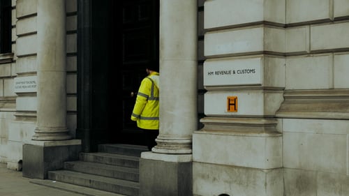 Short-range exterior shot of the entrance to a HMRC building in the UK.
