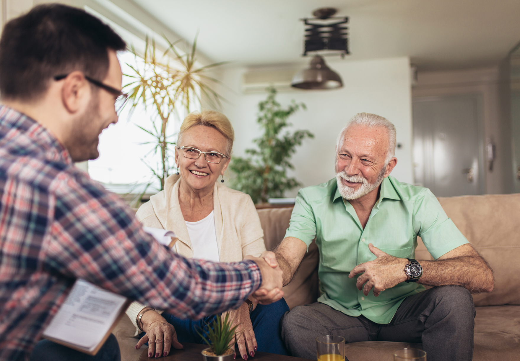 A veteran sitting beside his partner and shaking hands with a work colleague