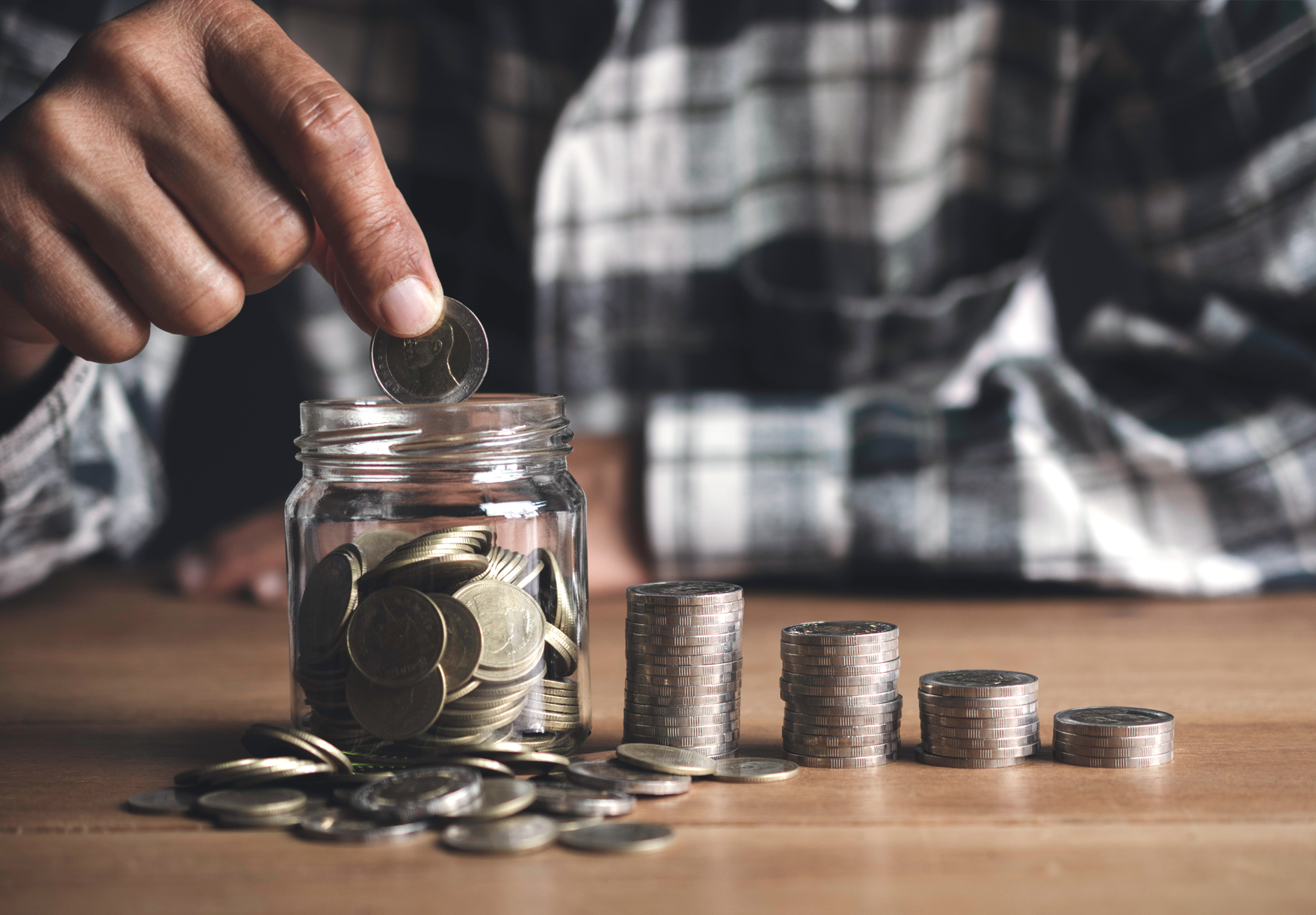 a person stacking piles of change