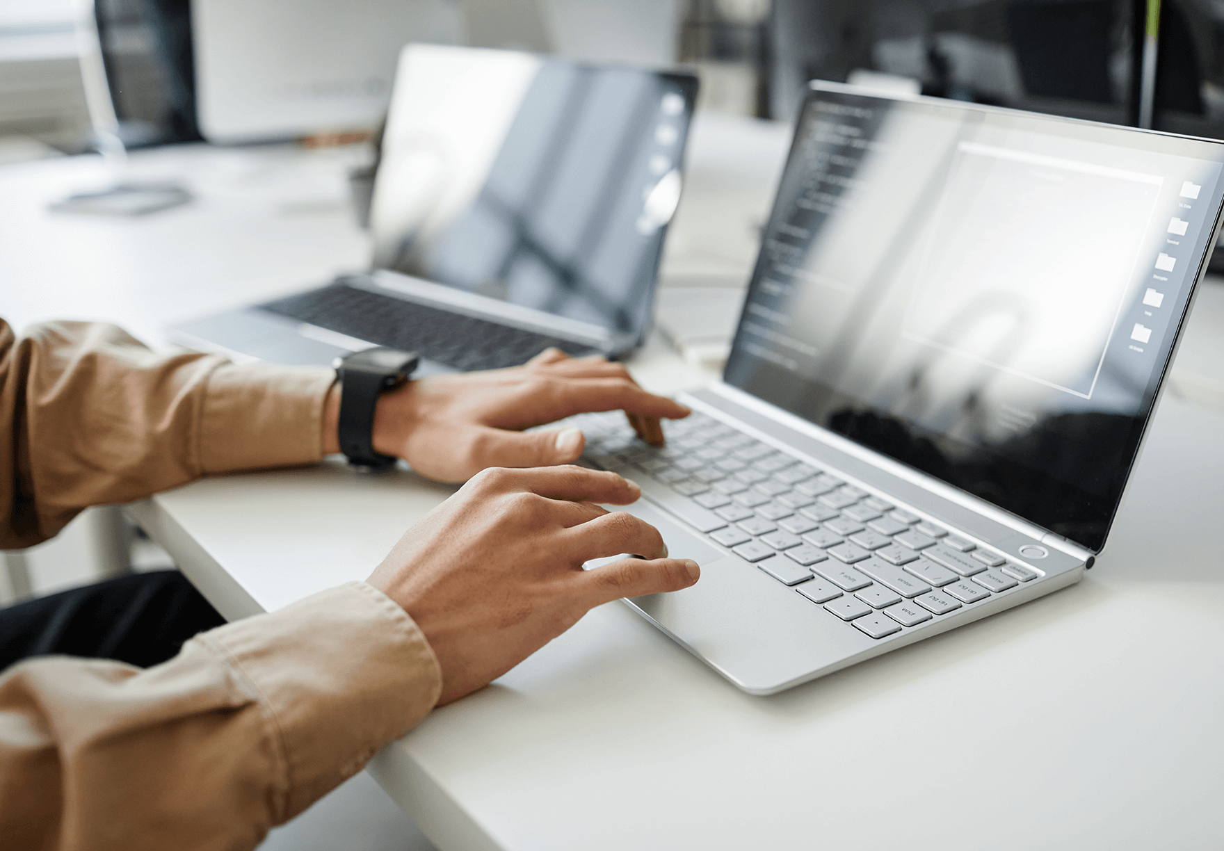 hands typing on a laptop