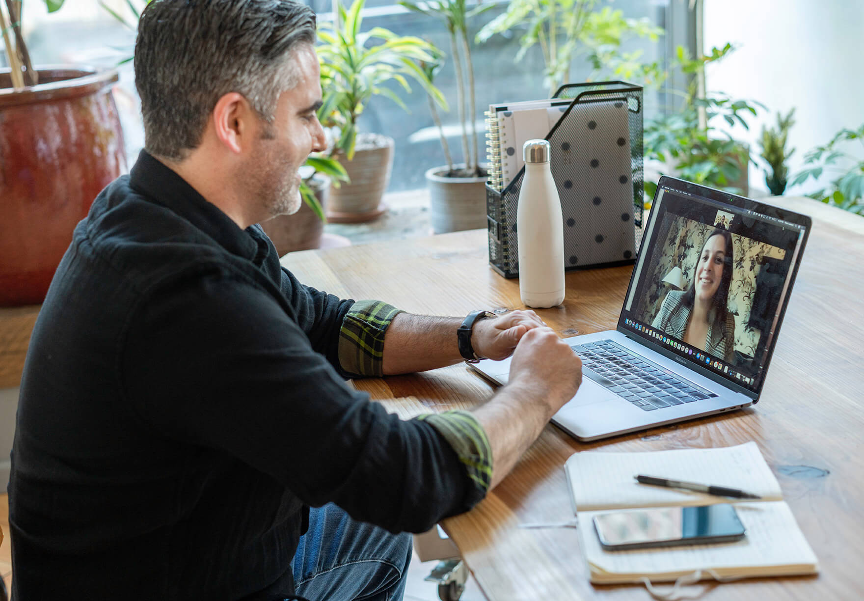 man in a video call with a woman on his laptop