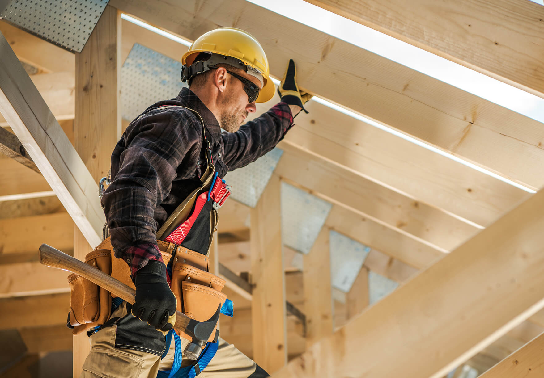 man working on a wooden house