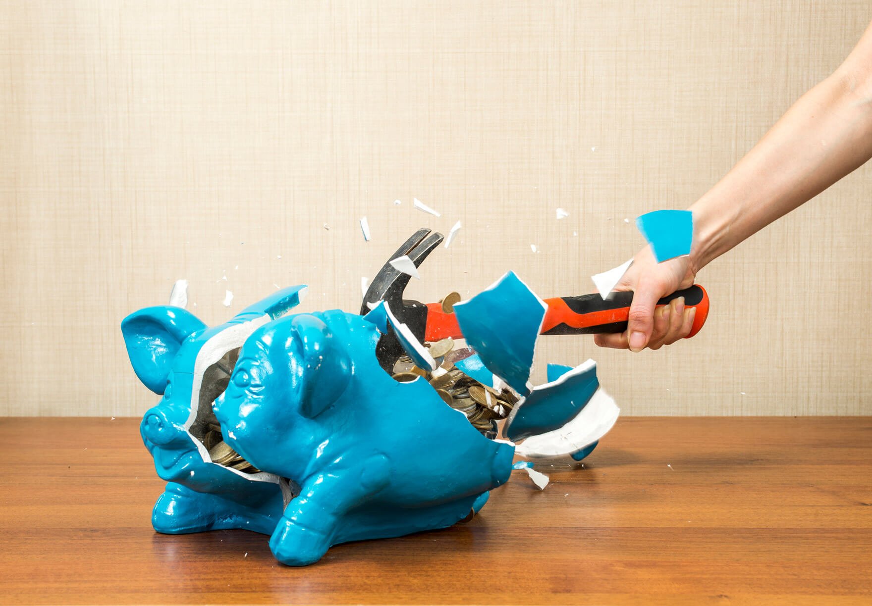 piggy bank being smashed with a hammer