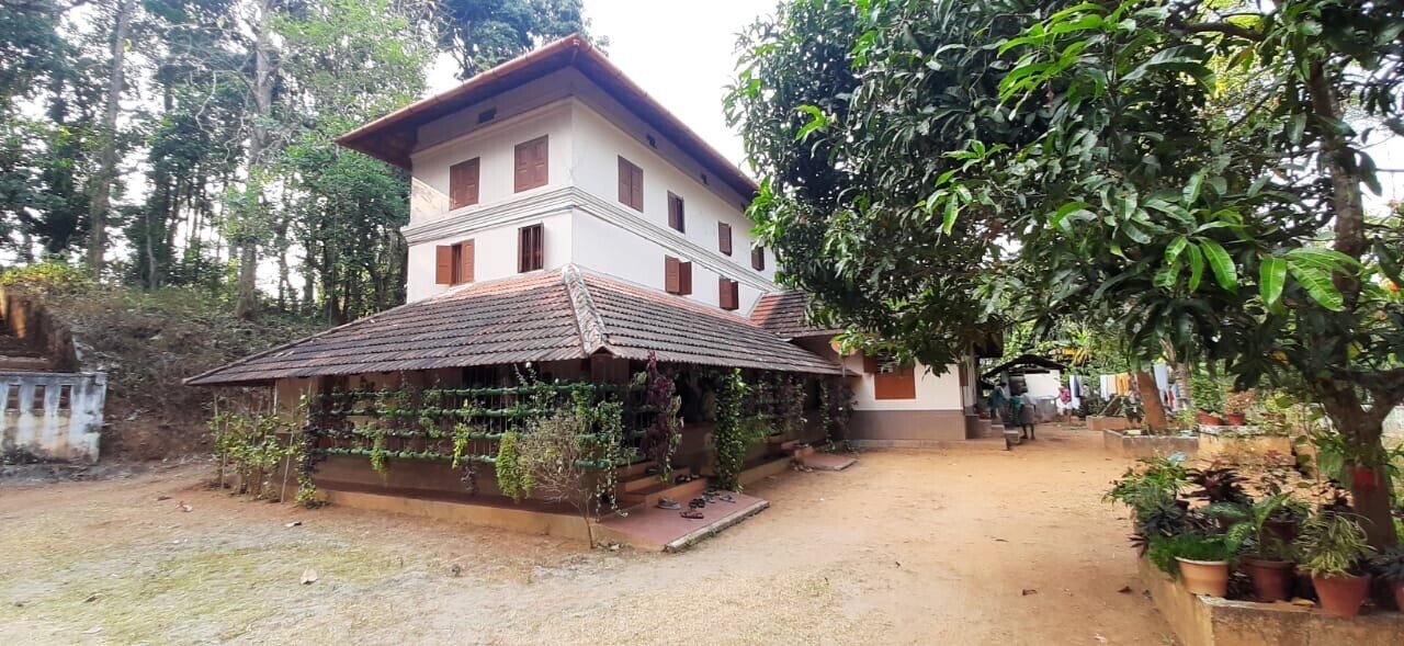 three-story building with trees