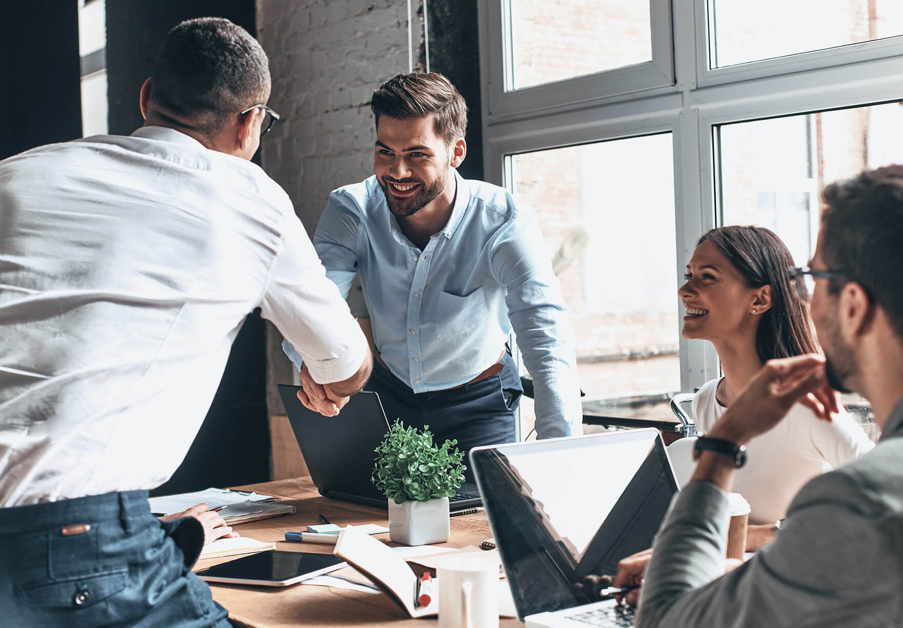 neurodivergent employee meeting with a collection of team members in an office setting