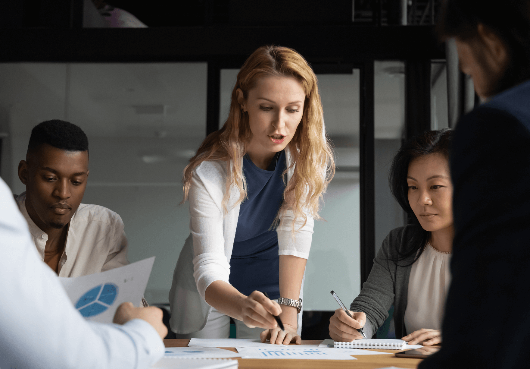 Retention Strategies Hero Image - Team members around a table 
