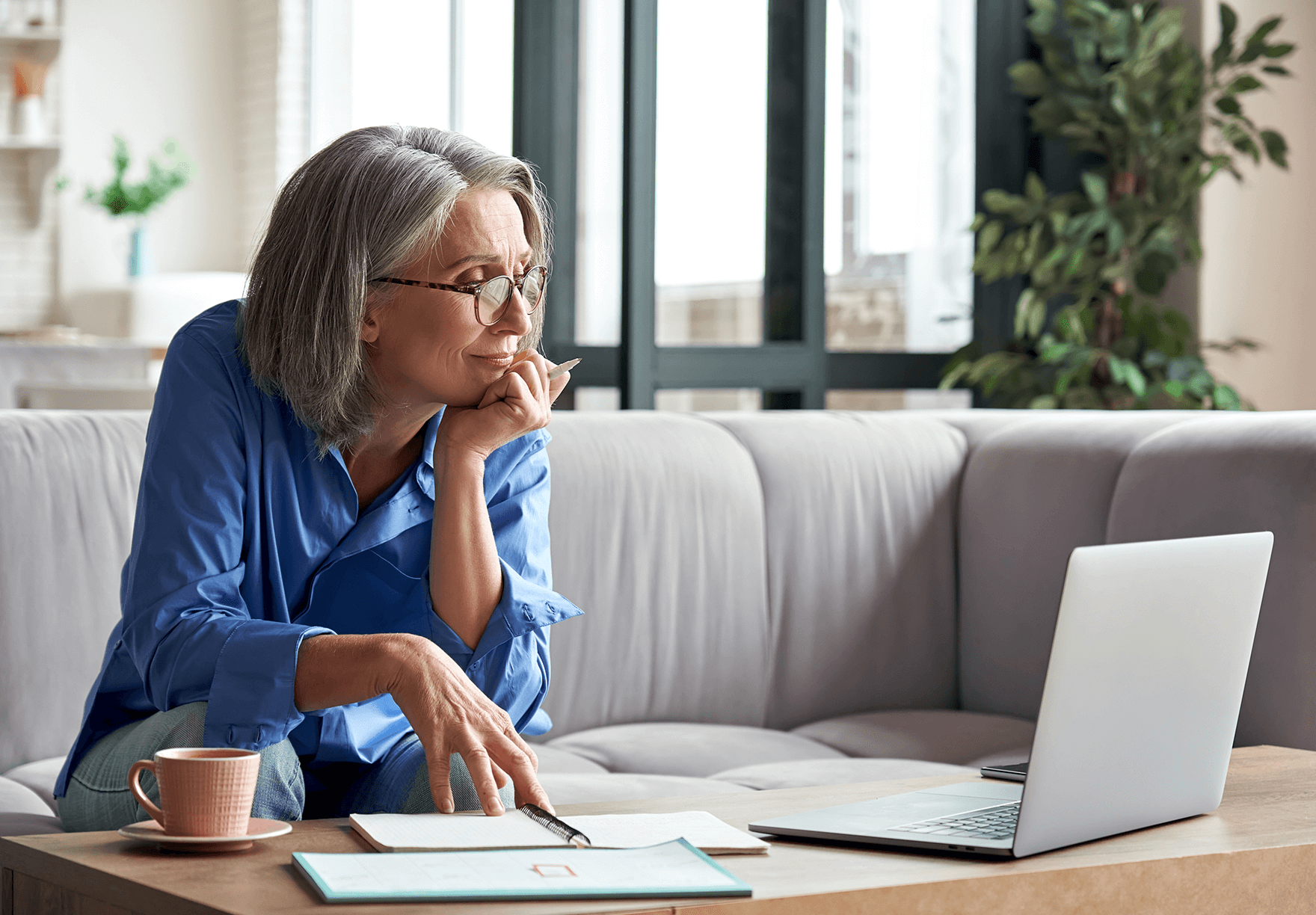 a woman taking notes during a virtual meeting